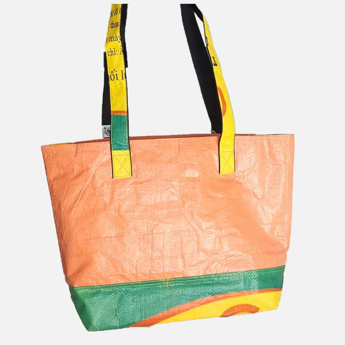 Tragetasche für das Shopping in orange mit buntem Boden. Zum Schultern geeignet.